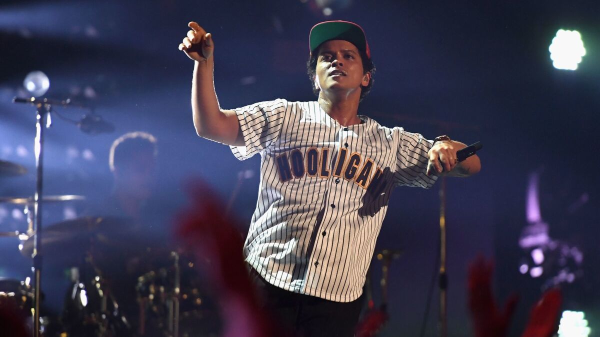 Bruno Mars, seen performing at June's BET Awards, employed his musicianly know-how in the first of four concerts at the Forum.