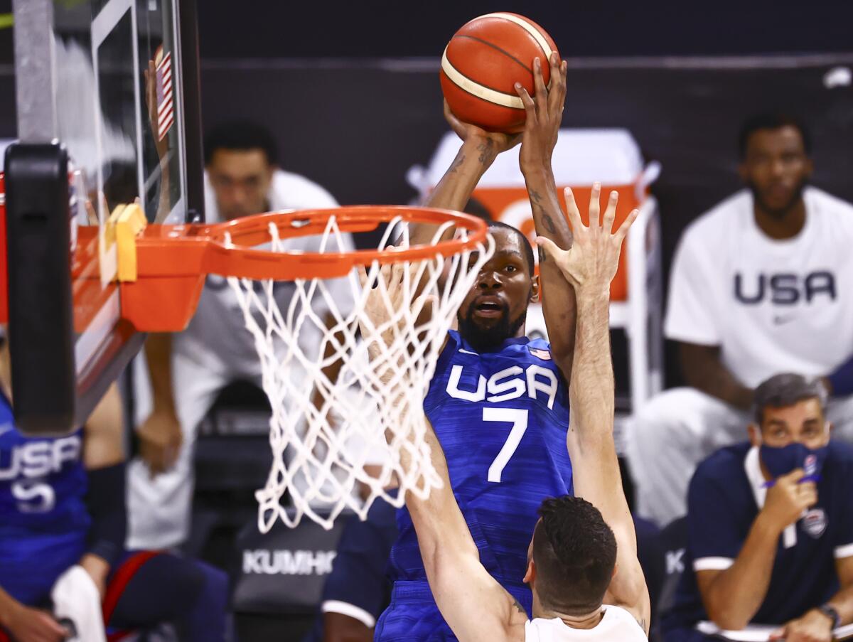 United States' Kevin Durant (7) shoots over Argentina's Patricio Garino during the first half of an exhibition basketball game in Las Vegas on Tuesday, July 13, 2021. (Chase Stevens/Las Vegas Review-Journal via AP)