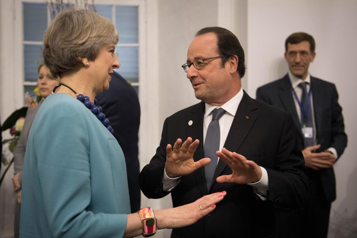 British Prime Minister Theresa May speaks with French President Francois Hollande during a meeting of European leaders in Malta.