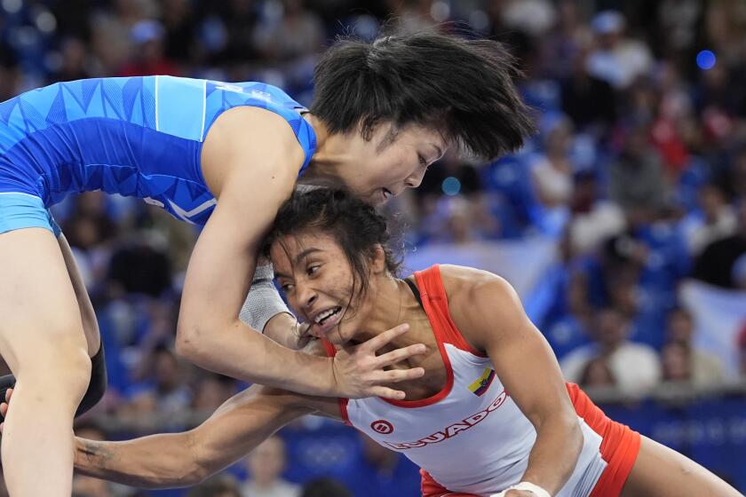 La ecuatoriana Lucía Yépez y la japonesa Akari Fujinami compiten en la final de los 53 kilogramos femeninos de la lucha libre en los Juegos Olímpicos de París, el jueves 8 de agosto de 2024. (AP Foto/Eugene Hoshiko)