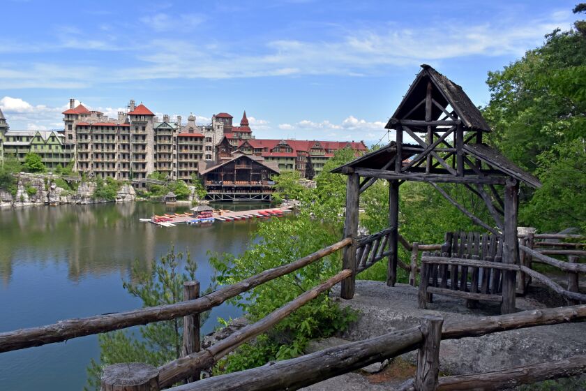 ULSTER COUNTY, NY - The Mountain House reflected in the lake and one of the rustic yet ornate "summer houses" close it hand combine for a classic scene of the essence of Mohonk.