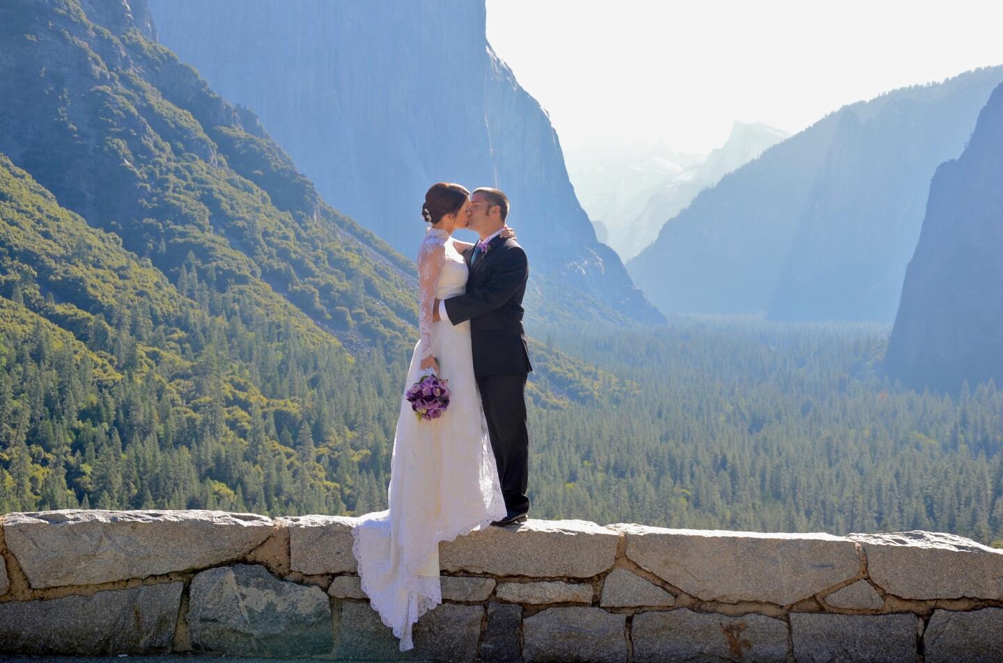 This couple, standing at Tunnel View in Yosemite Valley, hired a preacher and raced out to this popular viewpoint to say their vows first thing in the morning, before the first tour buses arrived. Photo taken in 2013.