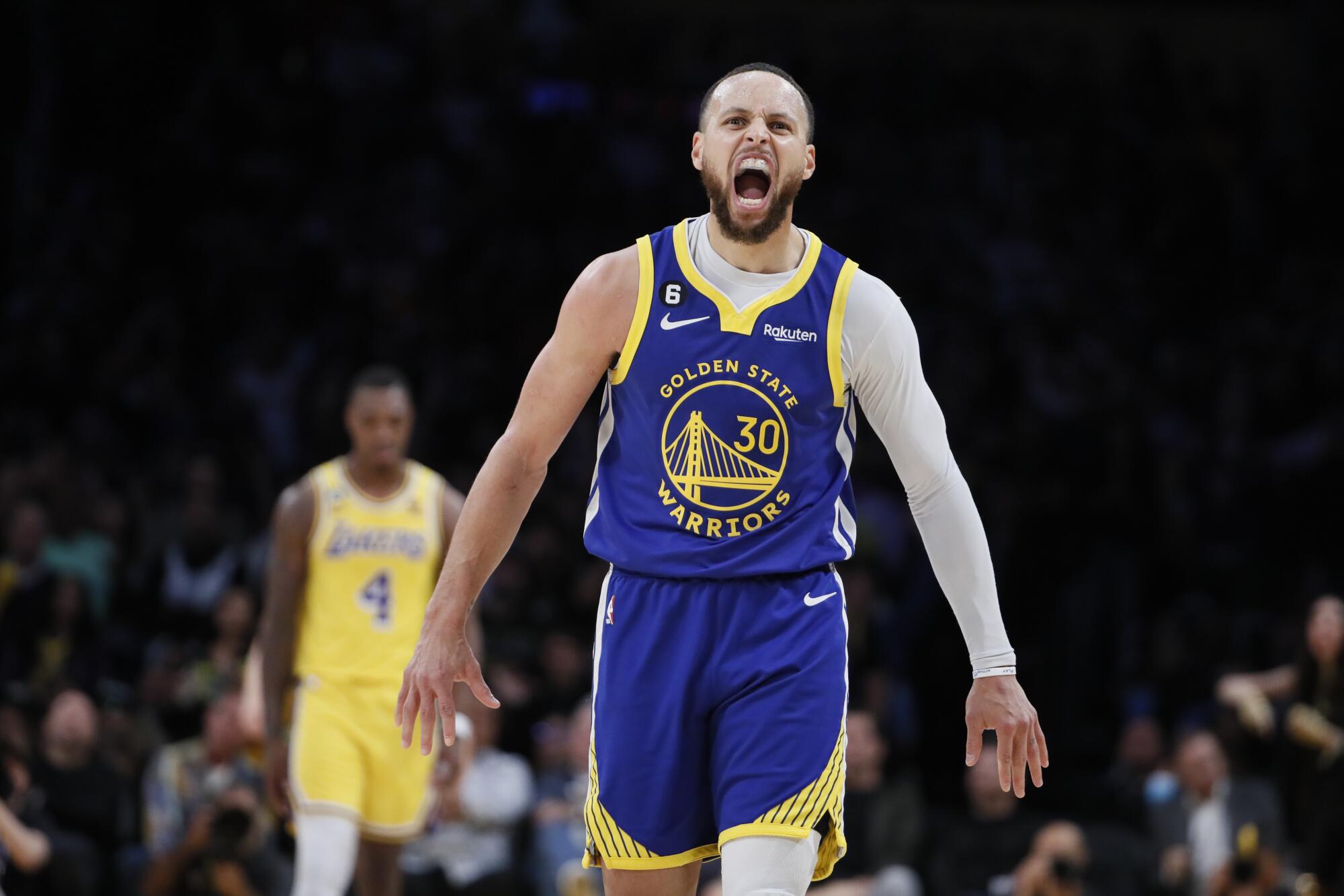 Warriors guard Stephen Curry yells out after hitting a three-pointer late in the game.
