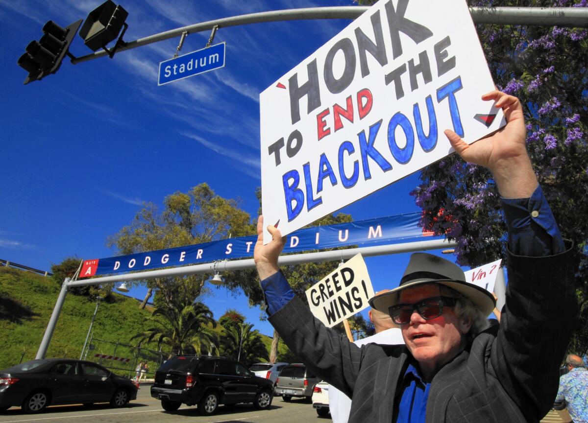 Bill Peterson, 54, of Los Angeles, and about 25 others protest protest the TV blackout outside Dodger Stadium last June.