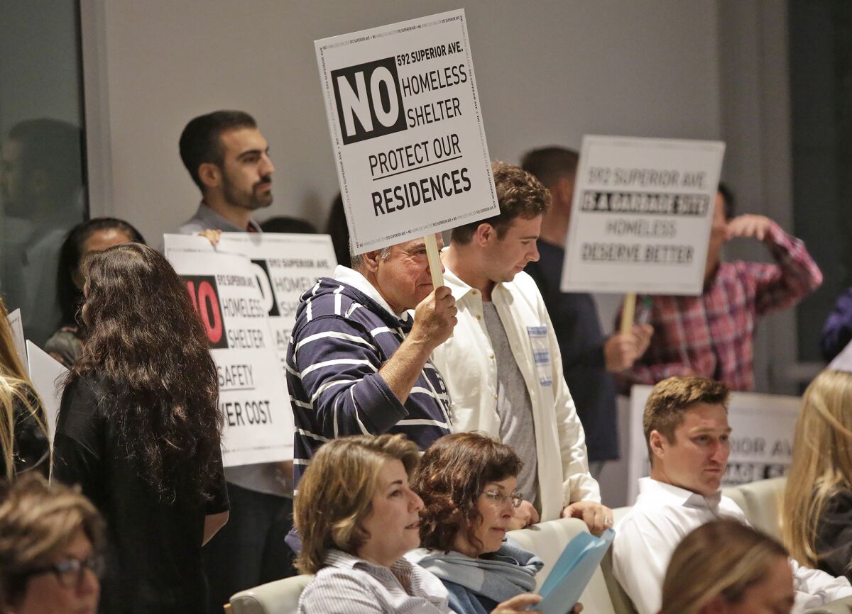 Residents protest at an Oct. 8 Newport Beach City Council meeting against a possible homeless shelter at 592 Superior Ave.