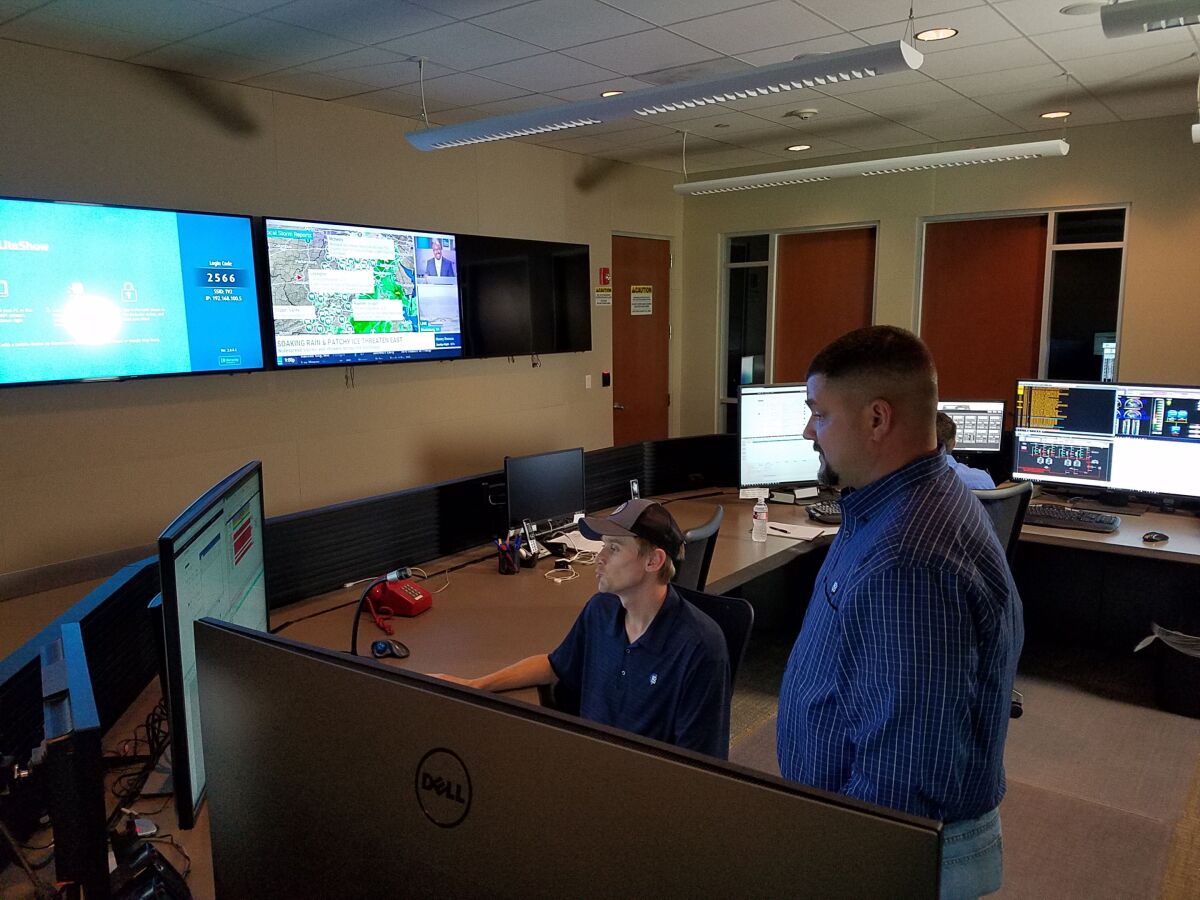 Max Baird, left, and Ray Meyer work in the control room of Texas utility Bluebonnet Electric Cooperative.