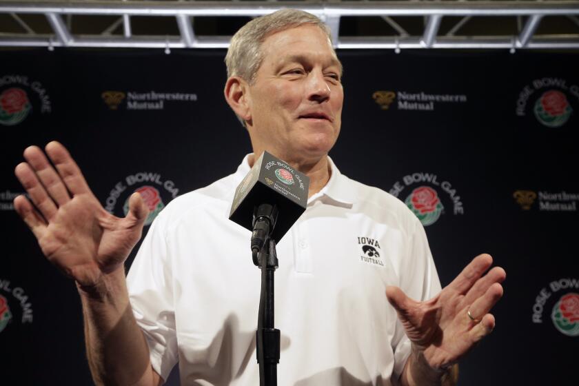Iowa Coach Kirk Ferentz talks to reporters during the team's Rose Bowl media day.