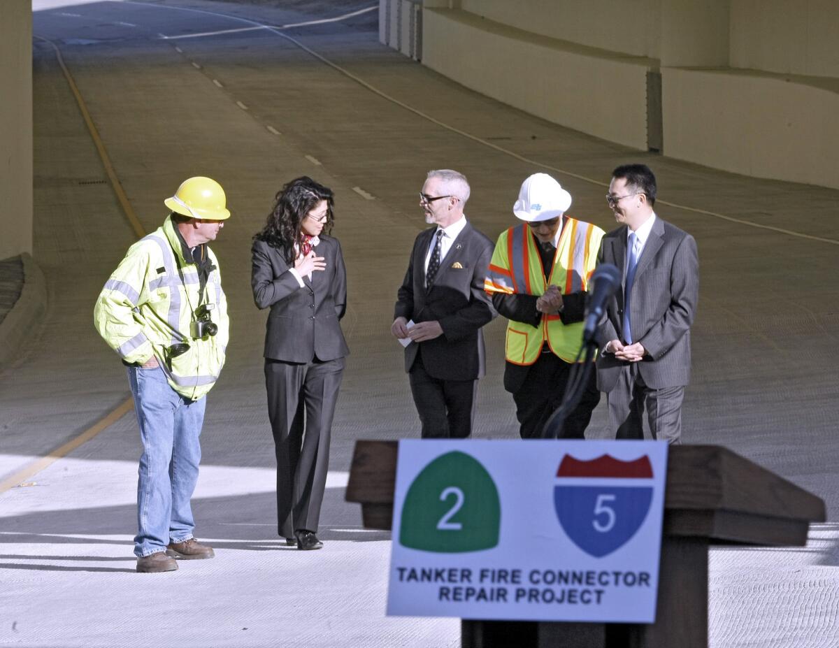 Officials walk the northbound Glendale SR-2 freeway connector to the northbound Golden State I-5 freeway in Echo Park that was completed and reopened by the California Department of Transportation on Friday, January 10, 2014. Known as the 2/5 Tanker Fire Connector Repair Project, it took six months for this section of the tunnel to reopen after the July 13, 2013 accident where a gasoline tanker flipped over and caught fire.