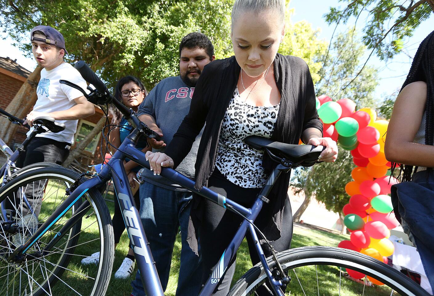 Molly Barney looks over one of the 17 bicycles that were donated to foster youth by Bikes 4 Orphans, a nonprofit started by two brothers while they were students at St. Francis High School.