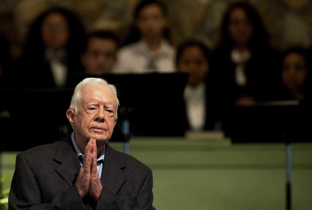 Former President Carter at prayer in 2015.
