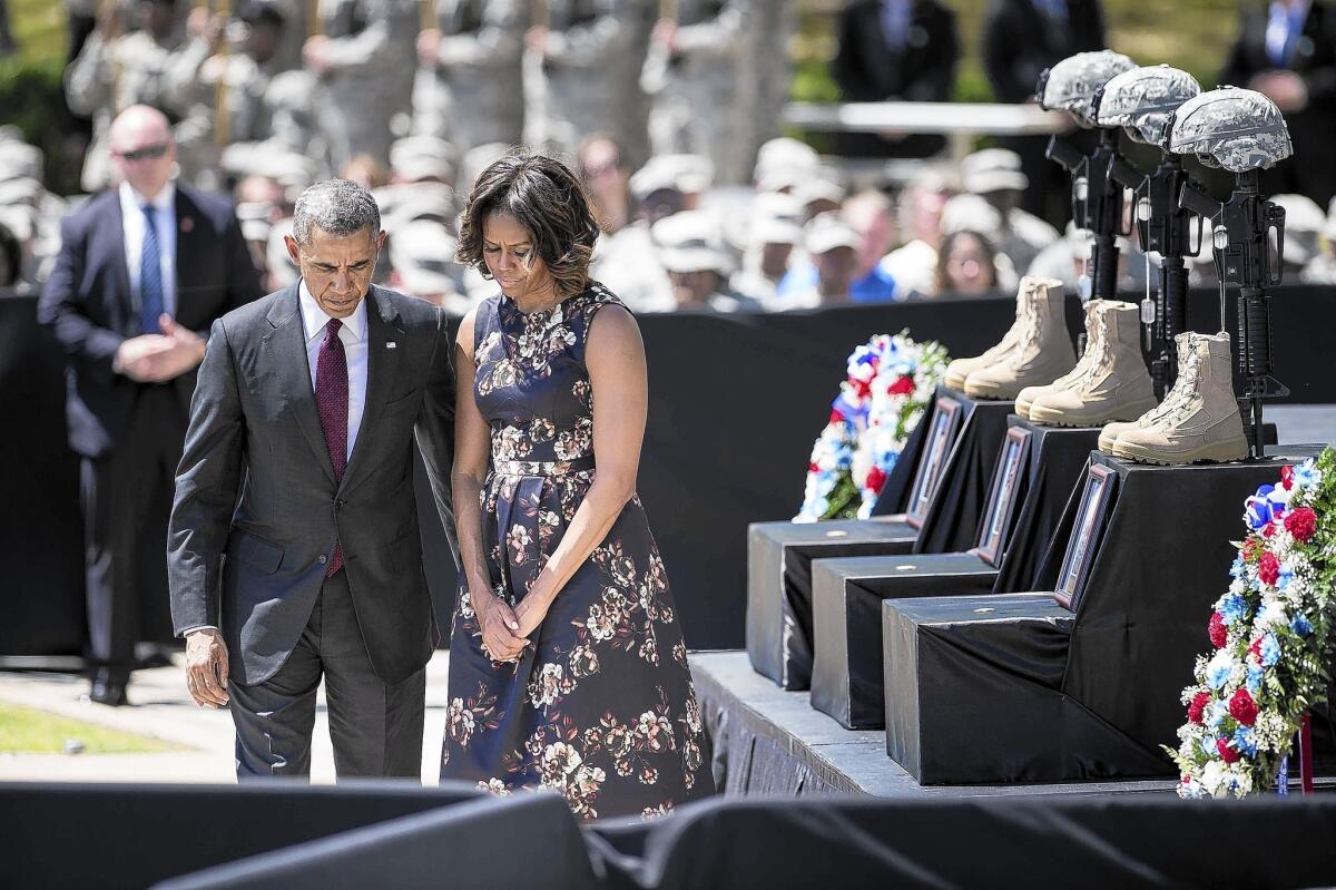 President Obama and First Lady Michelle Obama pay their respects during a memorial service at Ft. Hood. "With God's amazing grace we somehow bear what seems unbearable," he said.