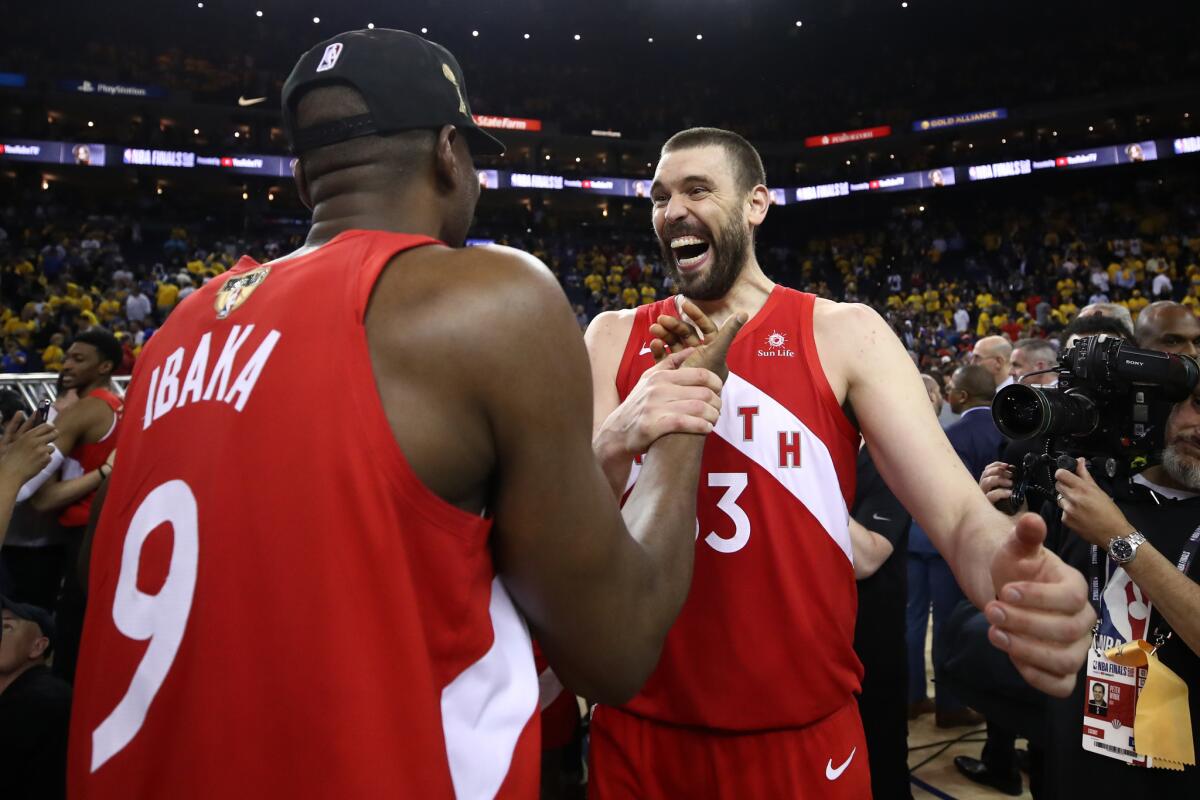 Serge Ibaka (9) and Marc Gasol of the Toronto Raptors celebrate their team's victory over the Golden State Warriors in Game Six to win the 2019 NBA Finals.
