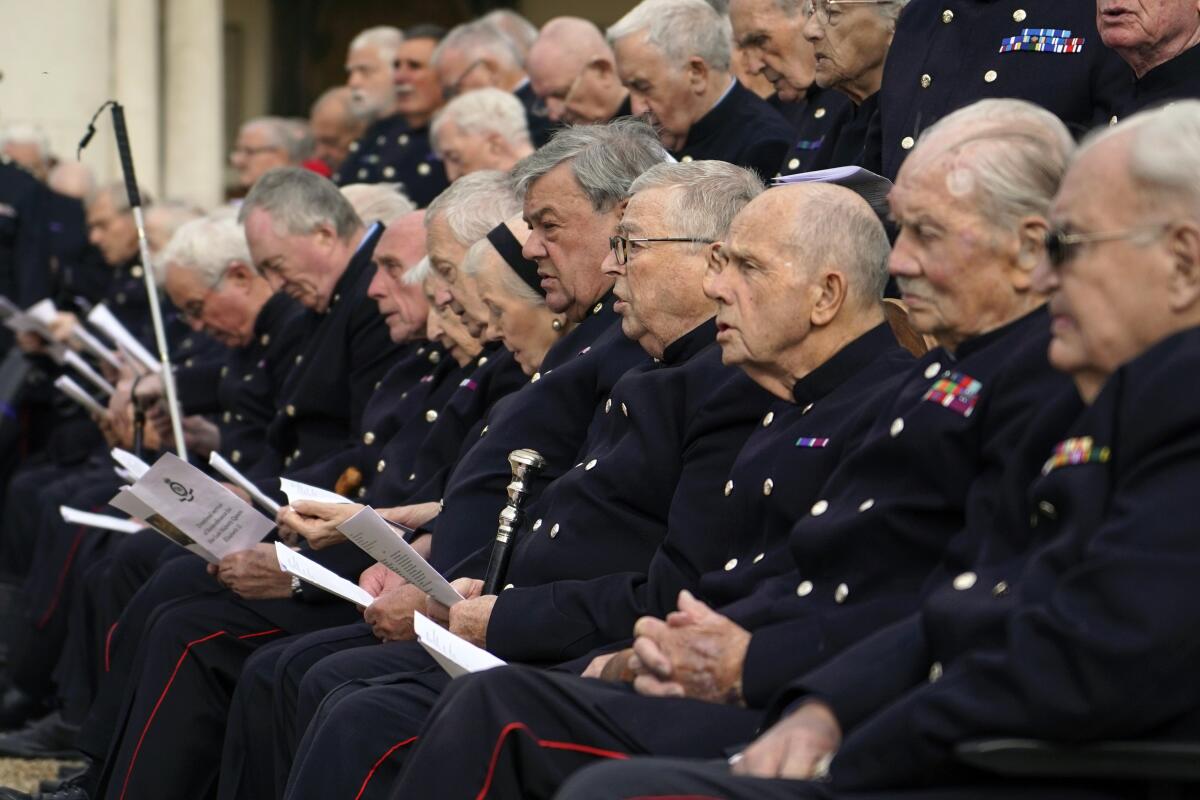 Pensioners take part in a service of remembrance for Britain's Queen Elizabeth II in London.