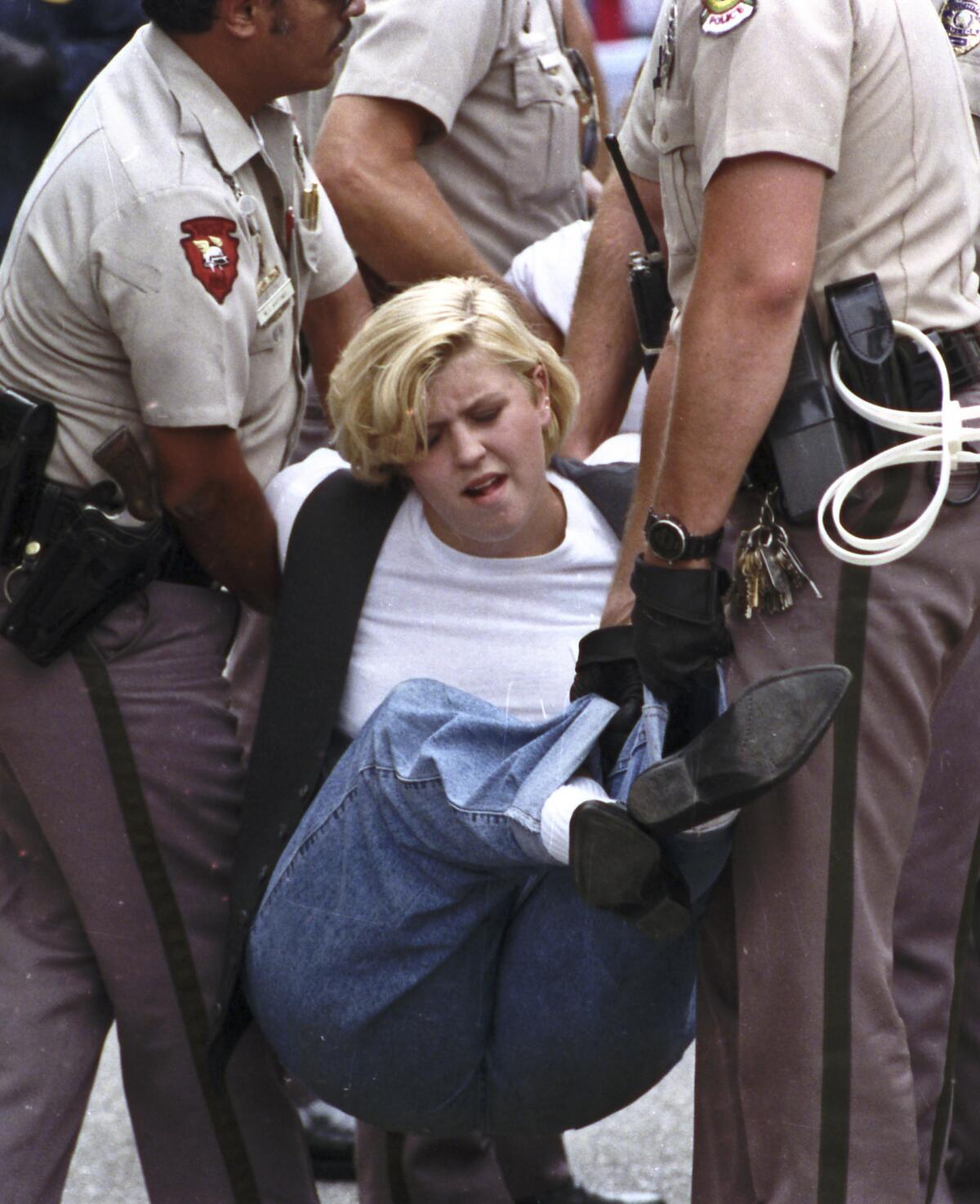 Aug. 25, 1991: Police carry away an anti-abortion protester in Wichita, Kan., during the "Summer of Mercy," when thousands of abortion opponents descended on the city, clogged streets with sit-ins, blocked clinic doors and filled the local jails. Demonstrations are planned again this summer to mark the 25th anniversary of the protests that led to nearly 2,700 arrests.