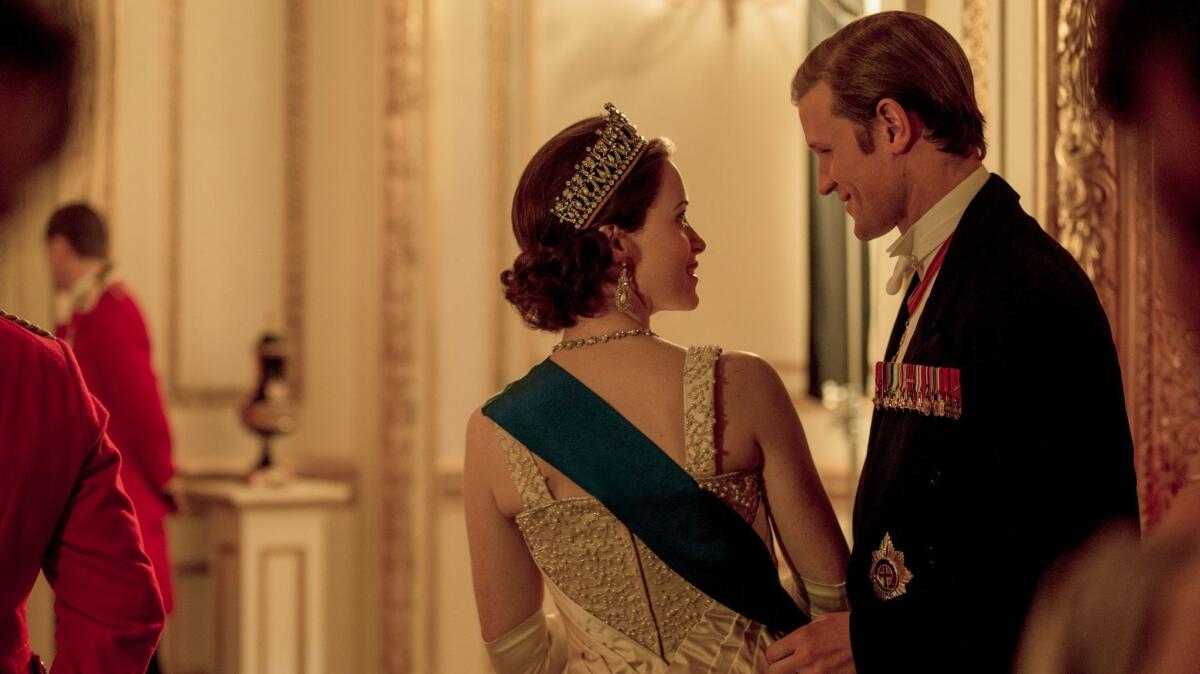 The queen (Claire Foy) and Prince Philip (Matt Smith) enjoy a private moment at the Ambassadors Ball in a scene from Season 2 of "The Crown."