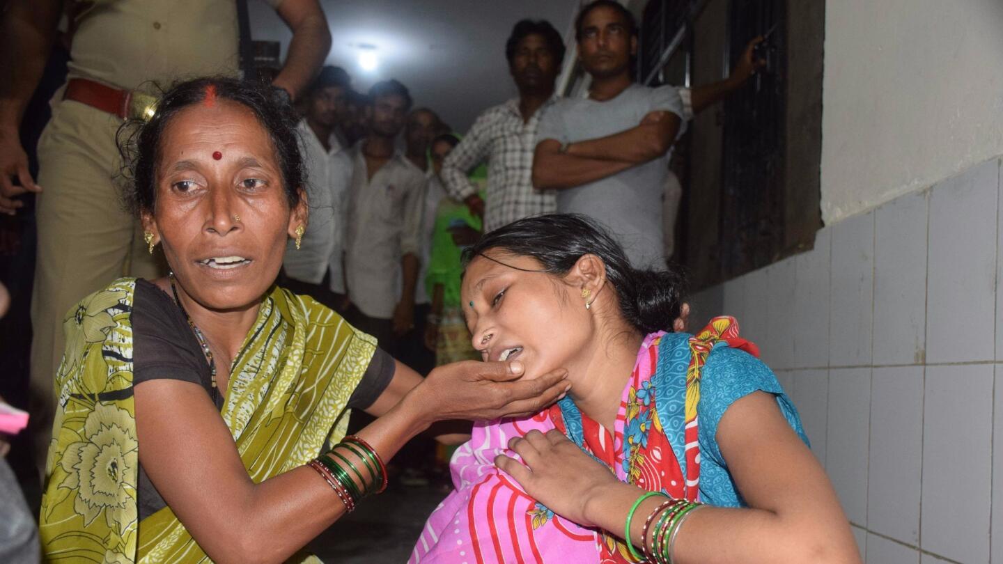 Relatives mourn the death of a child at Baba Raghav Das Hospital in Gorakhpur, India.