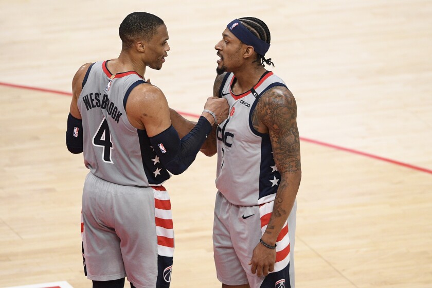Washington Wizards guard Russell Westbrook (4) and guard Bradley Beal (3) celebrate after an NBA basketball game against the Charlotte Hornets, Sunday, May 16, 2021, in Washington. (AP Photo/Nick Wass)
