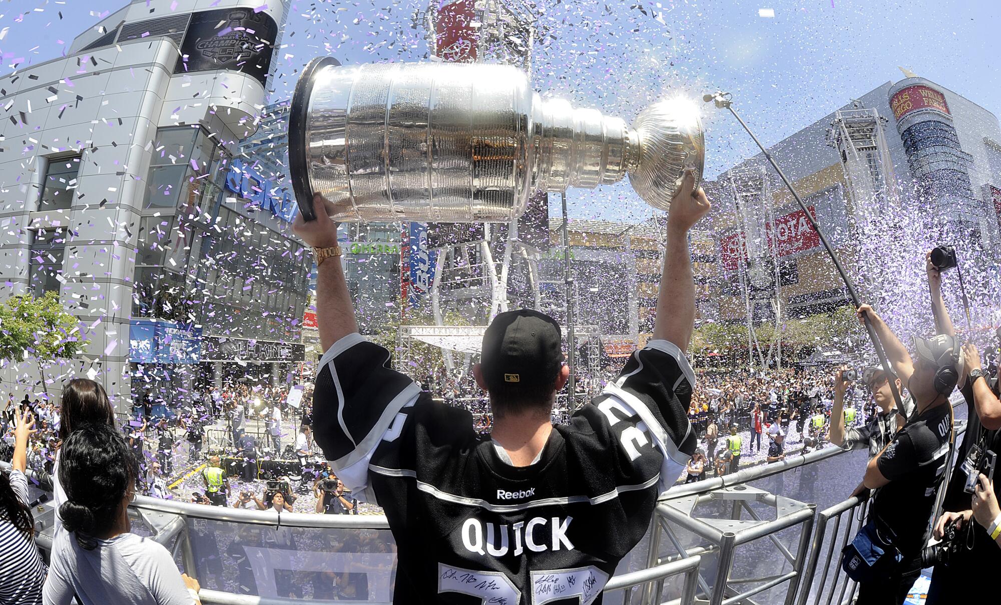 Kings goalie Jonathan Quick holds the Stanley Cup at the L.A. Live in downtown Los Angeles on June 16, 2014.