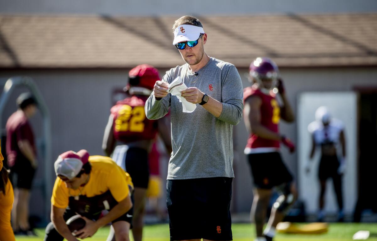 First-year USC coach Lincoln Riley checks his notes during spring practice March 22.