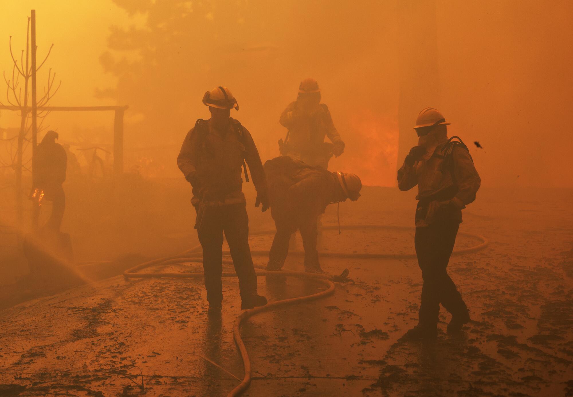 Firefighters struggle to breathe in thick smoke.