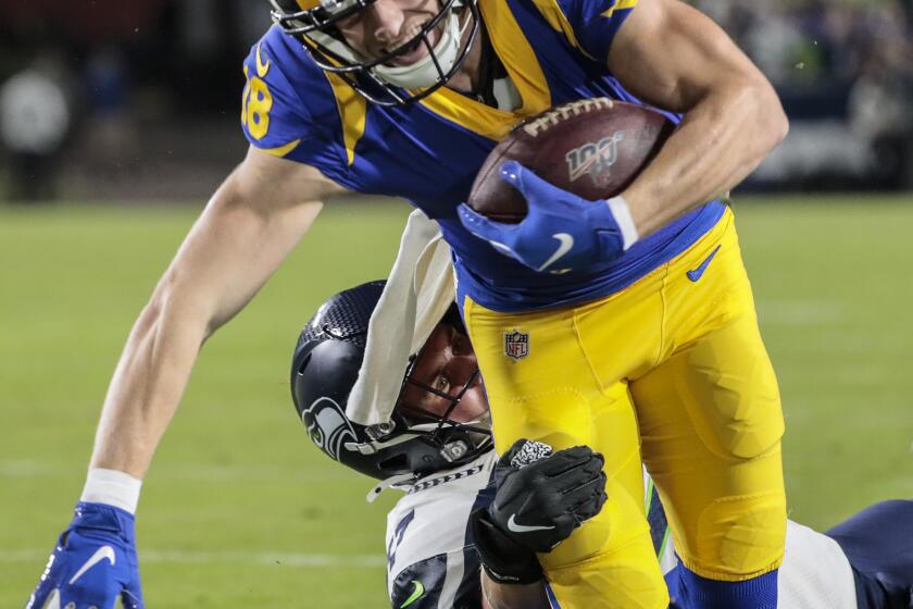 LOS ANGELES, CA, SUNDAY, DECEMBER 8, 2019 - Los Angeles Rams wide receiver Cooper Kupp (18) slips the tackle of Seattle Seahawks linebacker Cody Barton (57) after a catch near the goal line on a second quarter touchdown drive at LA Memorial Coliseum. (Robert Gauthier/Los Angeles Times)