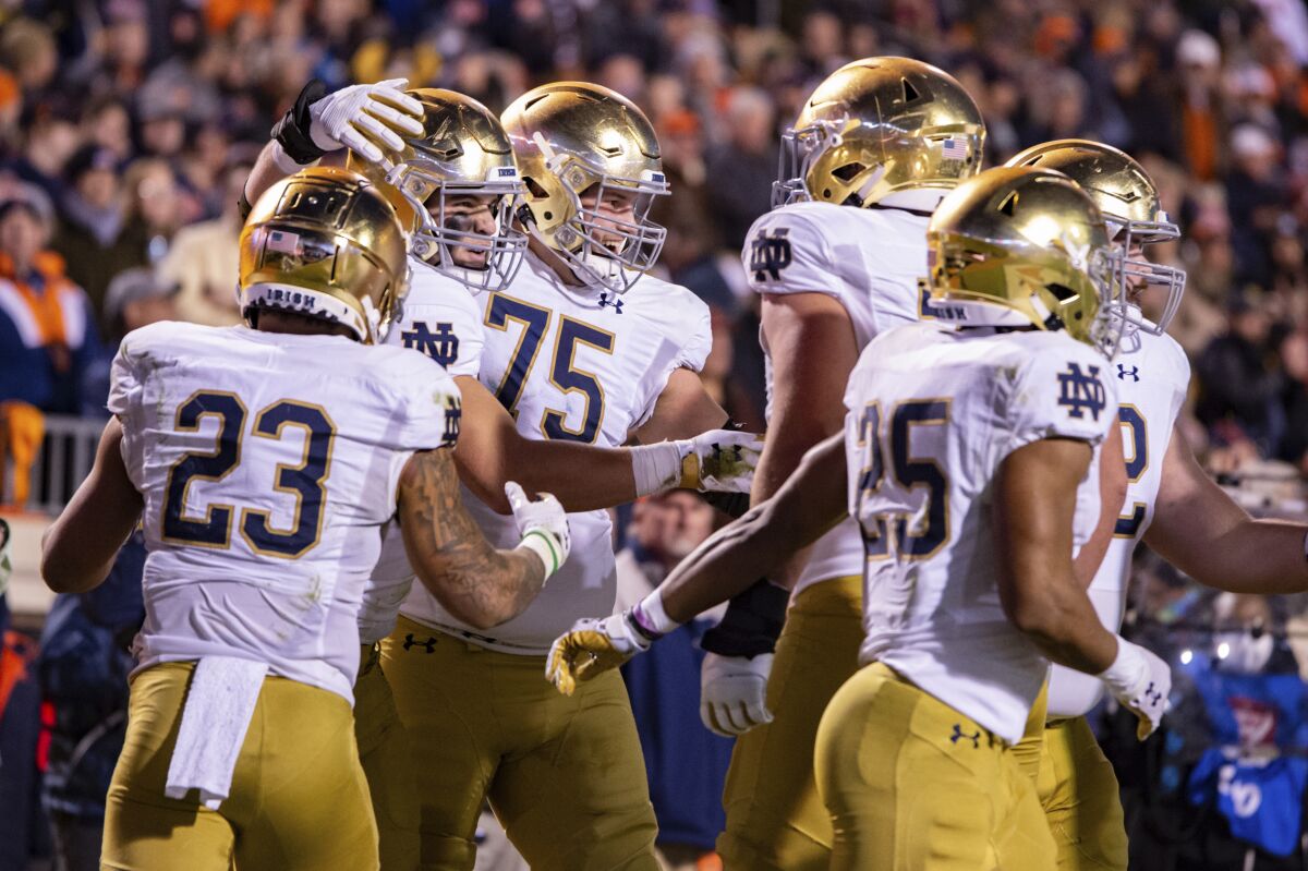 Notre Dame players celebrate after tight end Michael Mayer, second from left, scored a first-half touchdown.