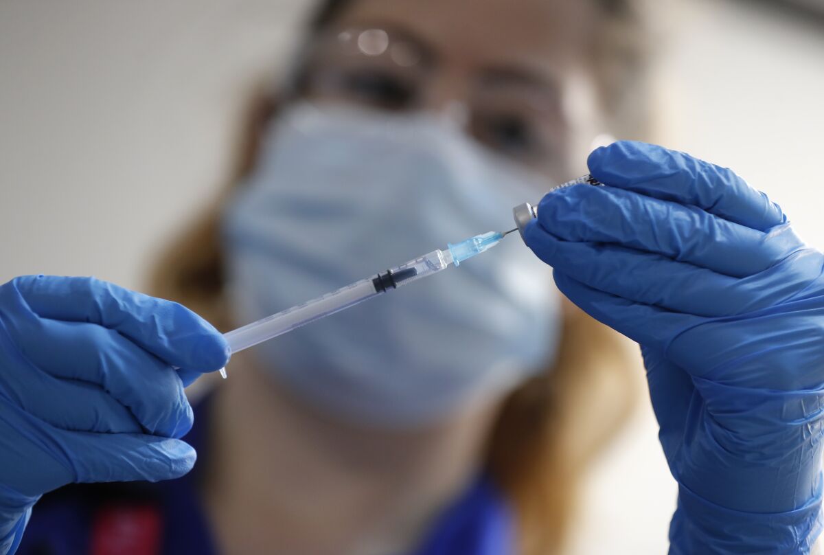 A nurse prepares to administer the Pfizer-BioNTech COVID-19 vaccine.