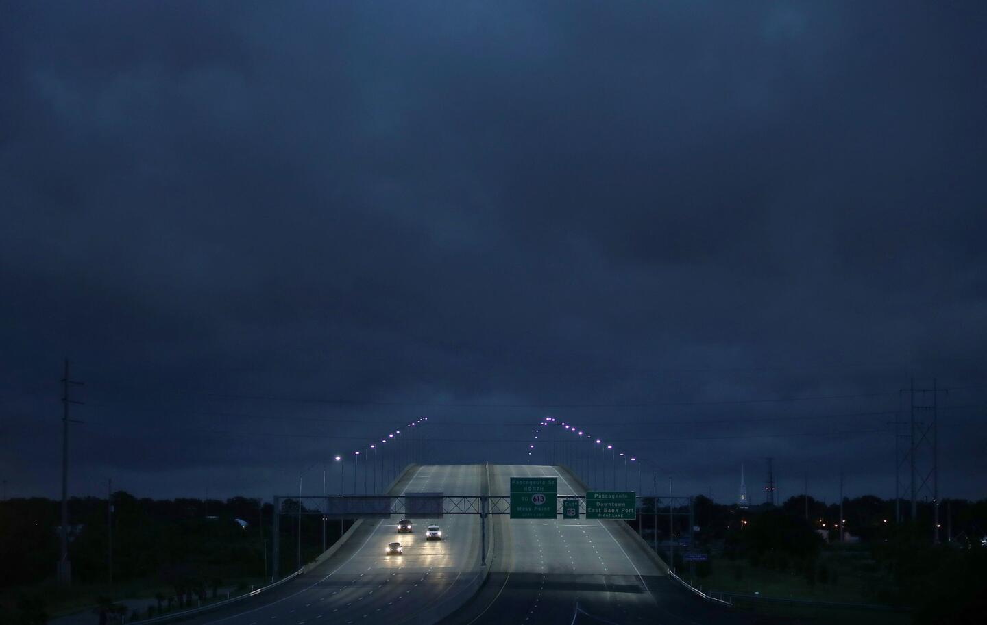 Vehicles pass over a U.S. Route 90 bridge as Tropical Storm Gordon continues to produce sporadic rain and wind in Pascagoula, Miss.