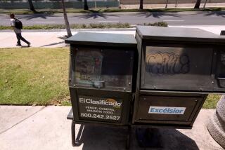 SANTA ANA, CA - JUNE 26, 2024 - An empty news rack that used to sell Spanish language newspaper Excelsior still remains standing along Bristol Street in a small shopping area in Santa Ana on June 26, 2024. There are no Spanish language newspapers being printed in Santa Ana. (Genaro Molina/Los Angeles Times)