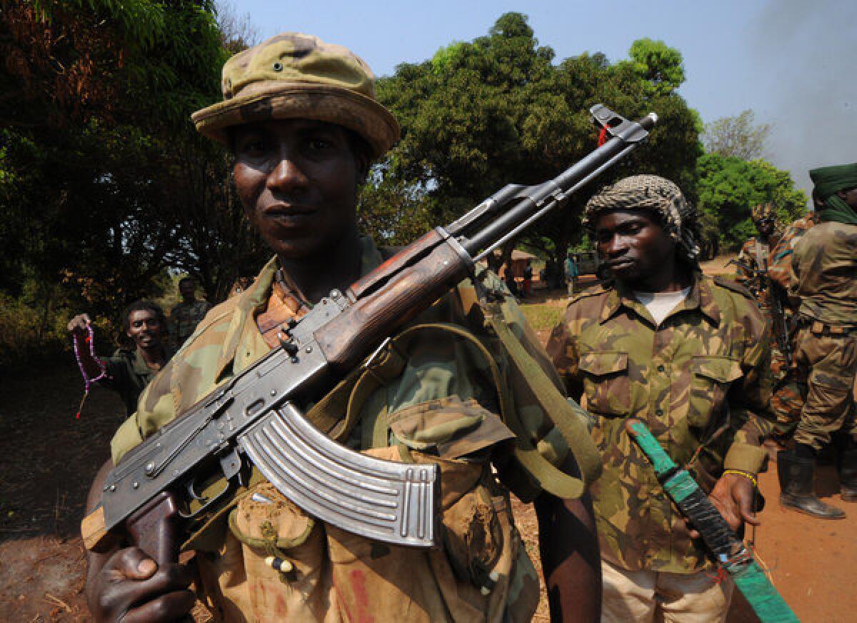 A file photo from Jan. 10, 2013, shows Seleka rebel coalition members taking up positions in a village 12 kilometers from Damara, where troops of the regional African force FOMAC are stationed. Rebels in the Central African Republic fighting to topple President Francois Bozize seized control of the capital Bangui on Sunday, and Bozize reportedly fled.