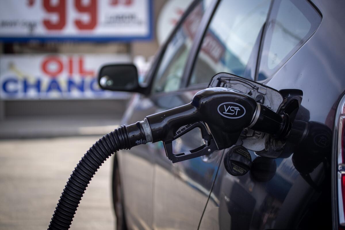 A motorist fills up a Toyota Prius at a Mobile gas station in Huntington Beach on Feb. 16. 