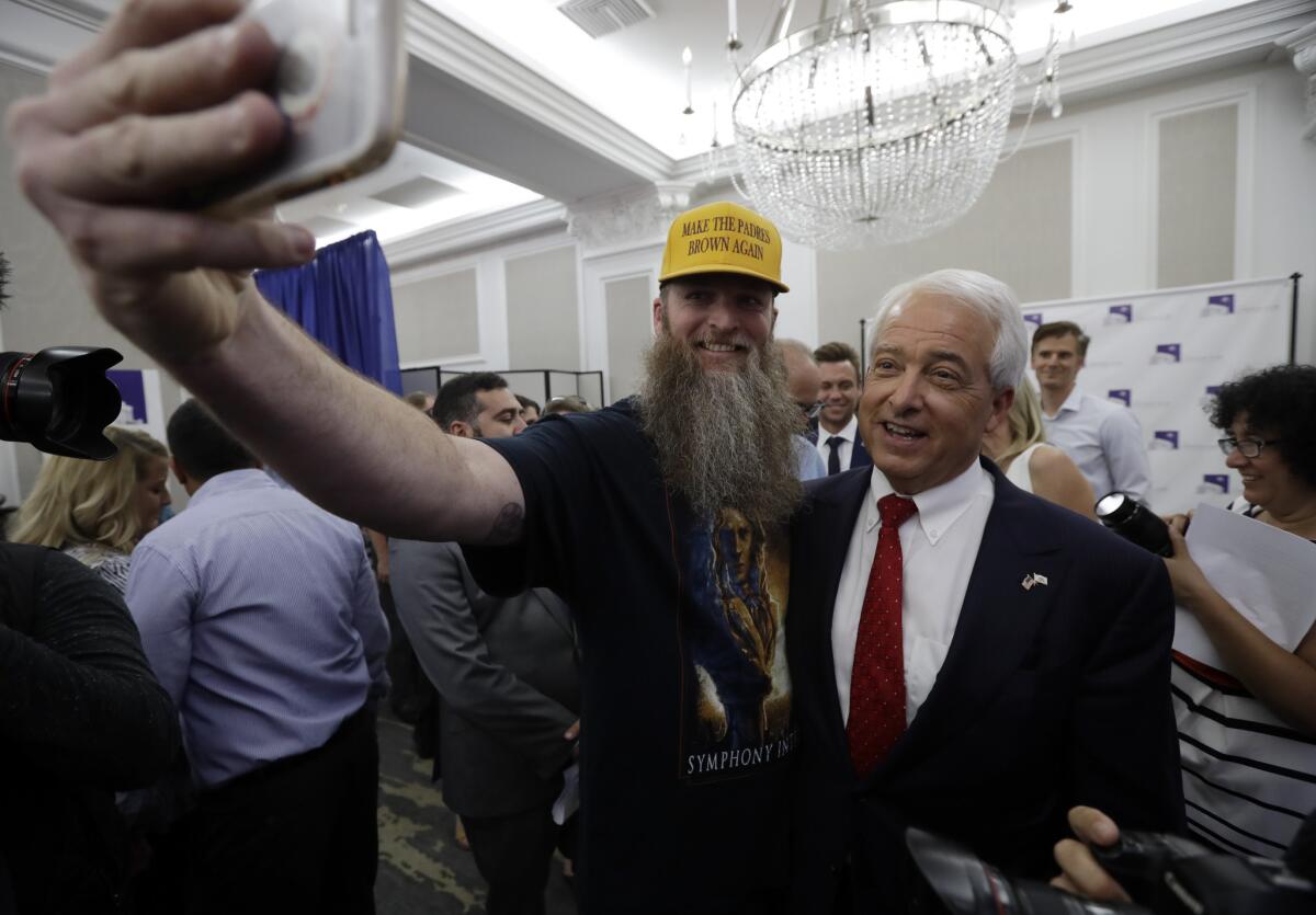 Republican gubernatorial candidate John Cox, right, stands with a supporter for a picture on Tuesday
