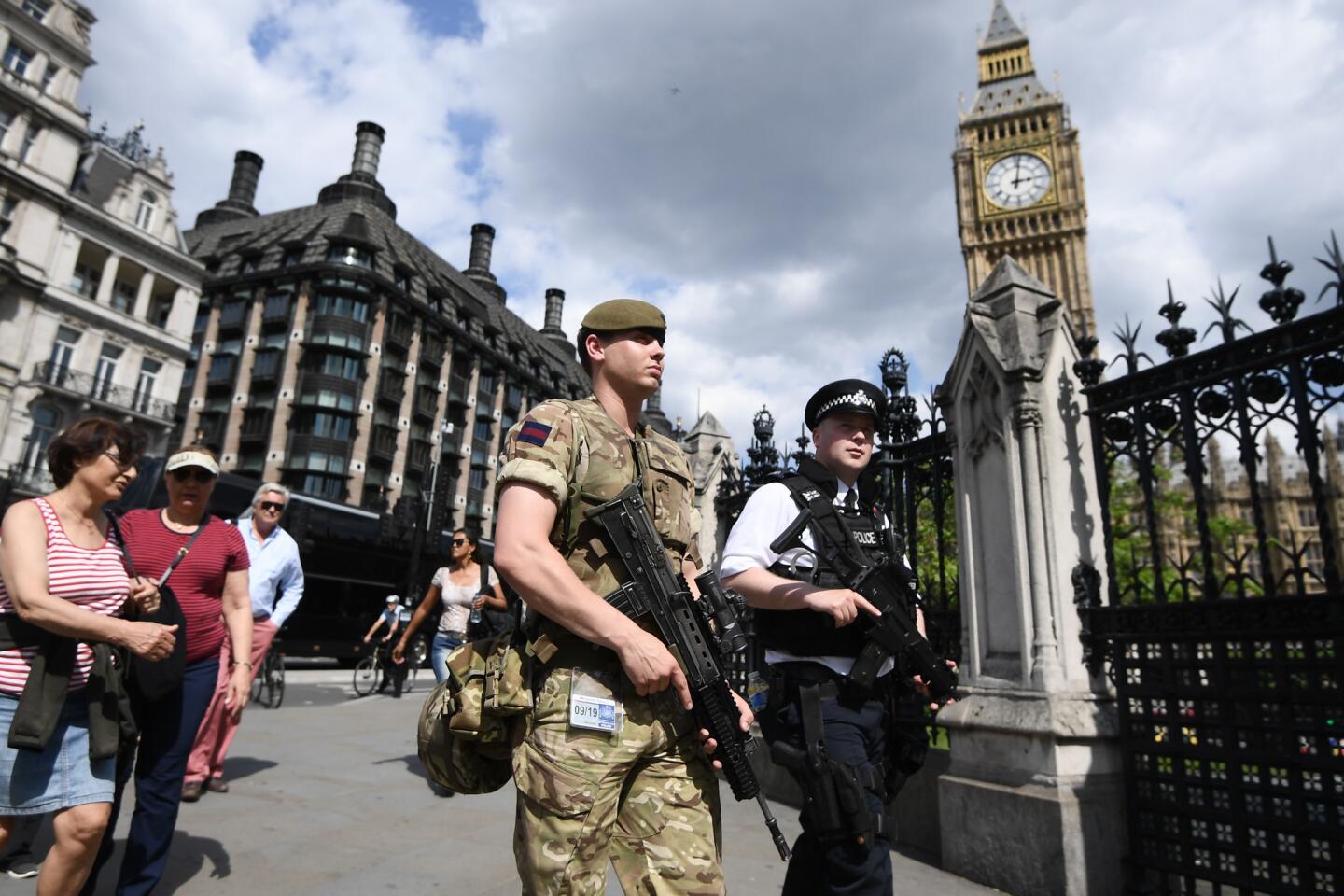 A soldier and police officer patrol outside the Houses of Parliament in London on Wednesday. Nearly a thousand military personnel are being deployed around the country as the UK terror status is elevated to critical in the wake of the terrorist attack at Manchester Arena.