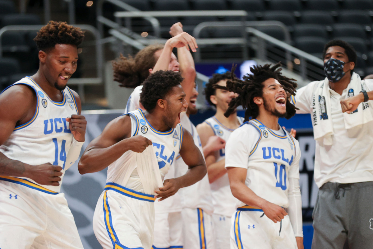 UCLA players celebrate on the court.