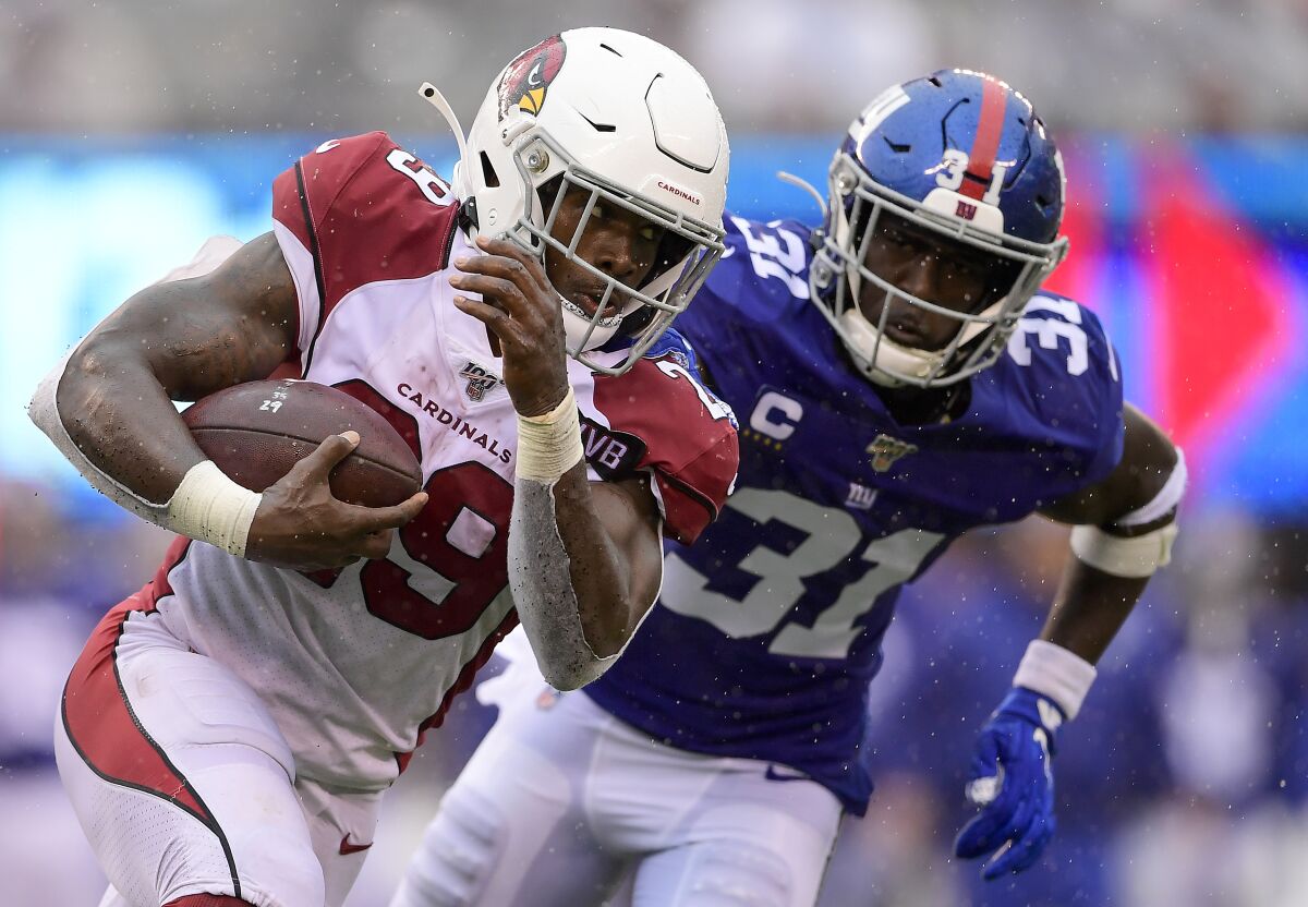 Arizona Cardinals running back Chase Edmonds sprints in front of New York Giants safety Michael Thomas during the Cardinals' win Sunday.