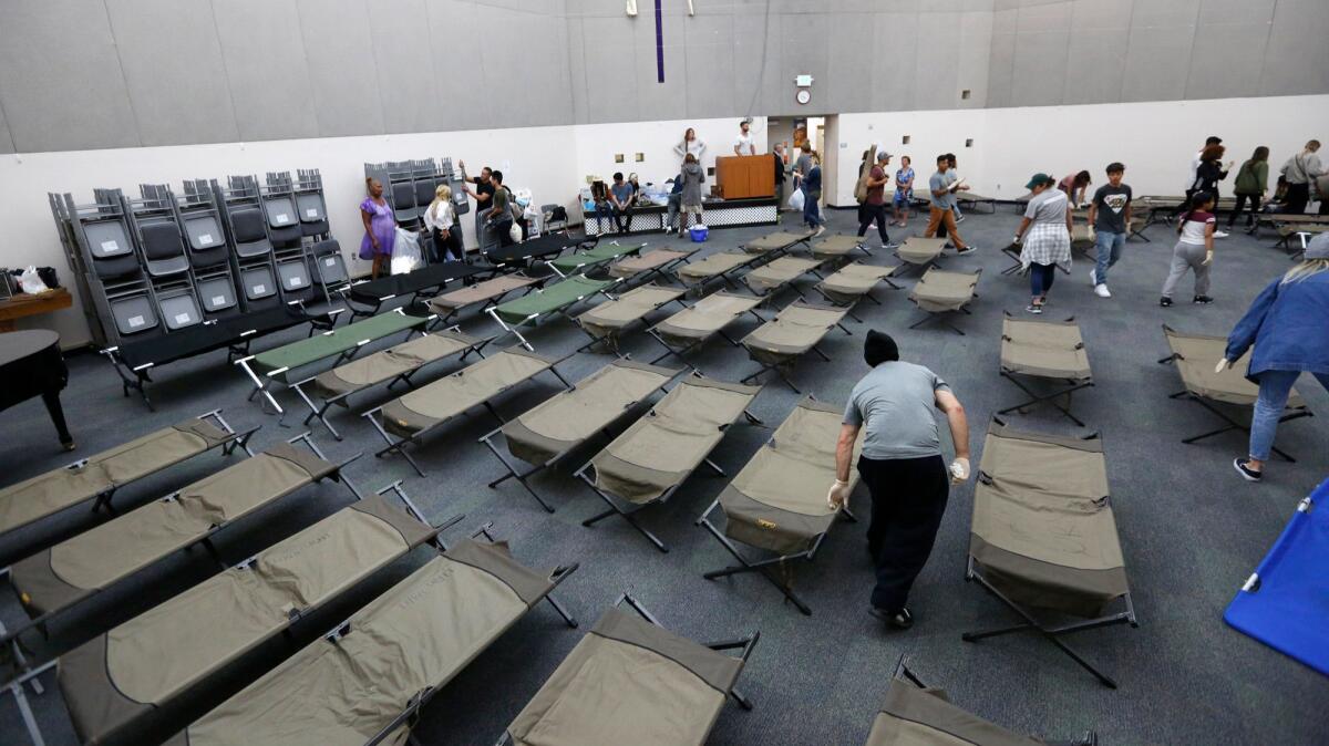 Cots are set up for the homeless to sleep on after a church service in the chapel at the Union Rescue Mission on skid row. The homeless shelter, designed for 890 people, takes in about 1,300 every night, using the chapel for overflow.