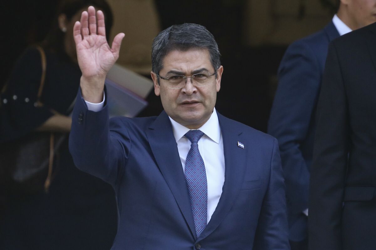FILE - President of Honduras Juan Orlando Hernandez waves as he exitsthe Academia Diplomatica de Chile where he met with President-elect Sebastian Pinera, in Santiago, Saturday, March 10, 2018. The Biden administration in 2021 quietly placed former Honduran President Juan Orlando Hernandez on a classified list of officials suspected of corruption or undermining democracy in Central America, according to two people familiar with the sanction, which is expected to be made public as early as Monday, Feb. 7, 2022. (AP Photo/Esteban Felix, File)