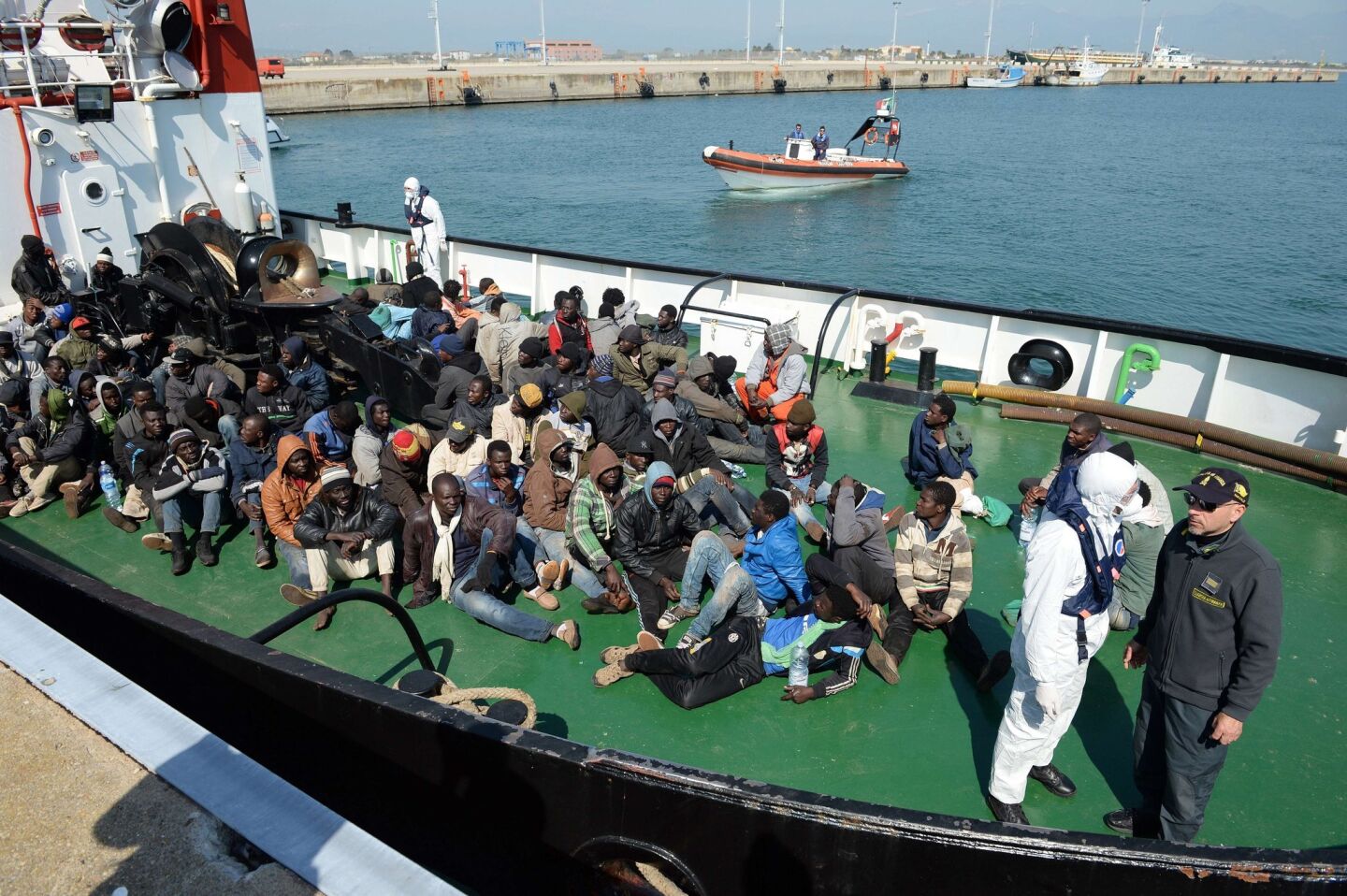 Survivors from the shipwreck of a boat arrive aboard the tanker Maria Bottiglieri on Wednesday in the port of Corigliano Calabro. The Italian coast guard intercepted 42 boats on April 12 and 13, carrying 6,500 migrants attempting to make the hazardous crossing to Europe.