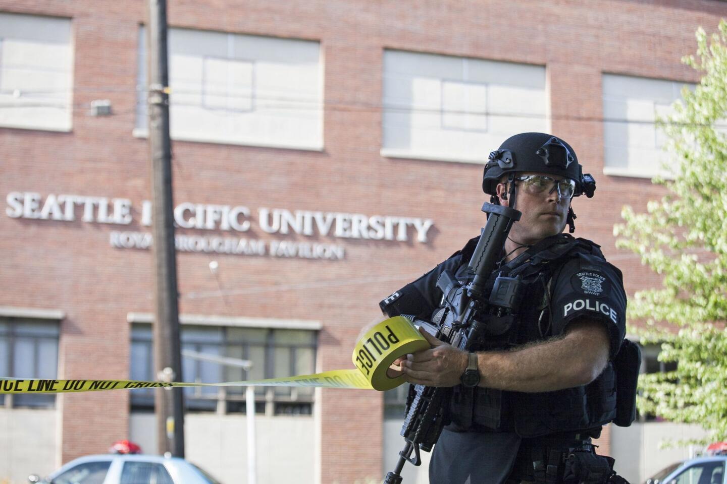 A policeman secures the scene at Seattle Pacific University after the campus was evacuated due to a shooting that left 1 dead and several wounded.