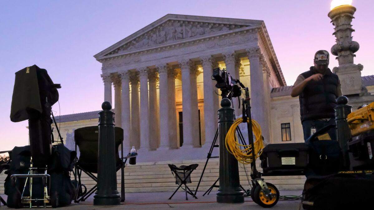 News crews set up outside the Supreme Court early Monday on the first day of the court's new term.