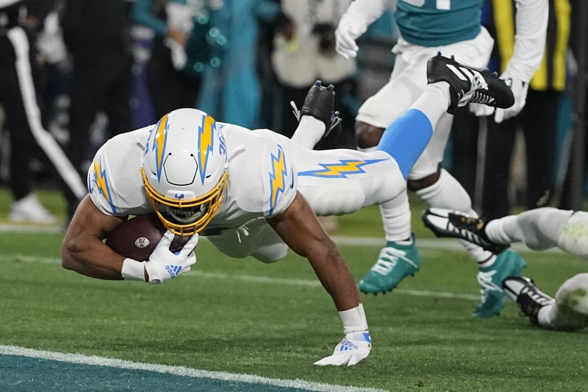 Chargers running back Austin Ekeler leaps into the end zone to score a touchdown in the first quarter.