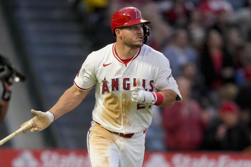 Los Angeles Angels' Mike Trout tosses his bat after hitting a home run during the third inning.