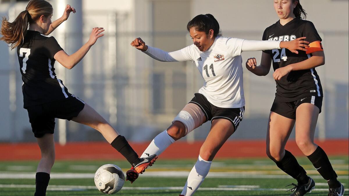 Los Amigos High's Vidalia Abarca (11), shown battling two South Pasadena defenders on Feb. 27, 2018, scored two of the Lobos' goals in a 3-0 CIF Southern Section Division 5 semifinal win over Thermal Coachella Valley at Garden Grove High on Saturday.