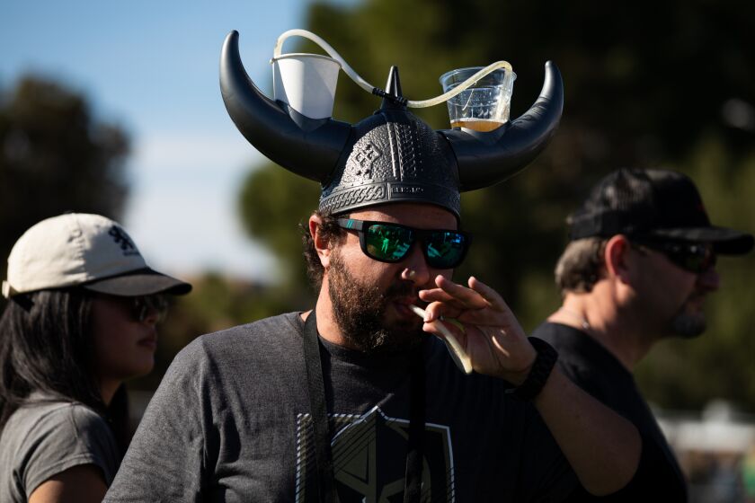 Edward Kissinger drinks beer from his Viking beer helmet during the 12th annual San Diego Beer Fest at Liberty Station NTC Park on Saturday, Jan 7, 2022.