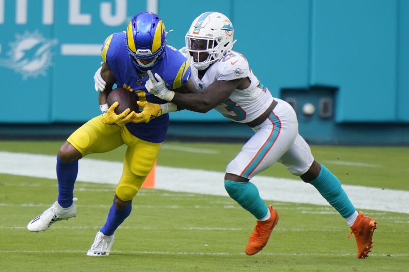 Miami Dolphins cornerback Noah Igbinoghene (23) tackles Los Angeles Rams wide receiver Robert Woods (17), during the second half of an NFL football game, Sunday, Nov. 1, 2020, in Miami Gardens, Fla. The Dolphins defeated the Rams 28-17. (AP Photo/Wilfredo Lee)
