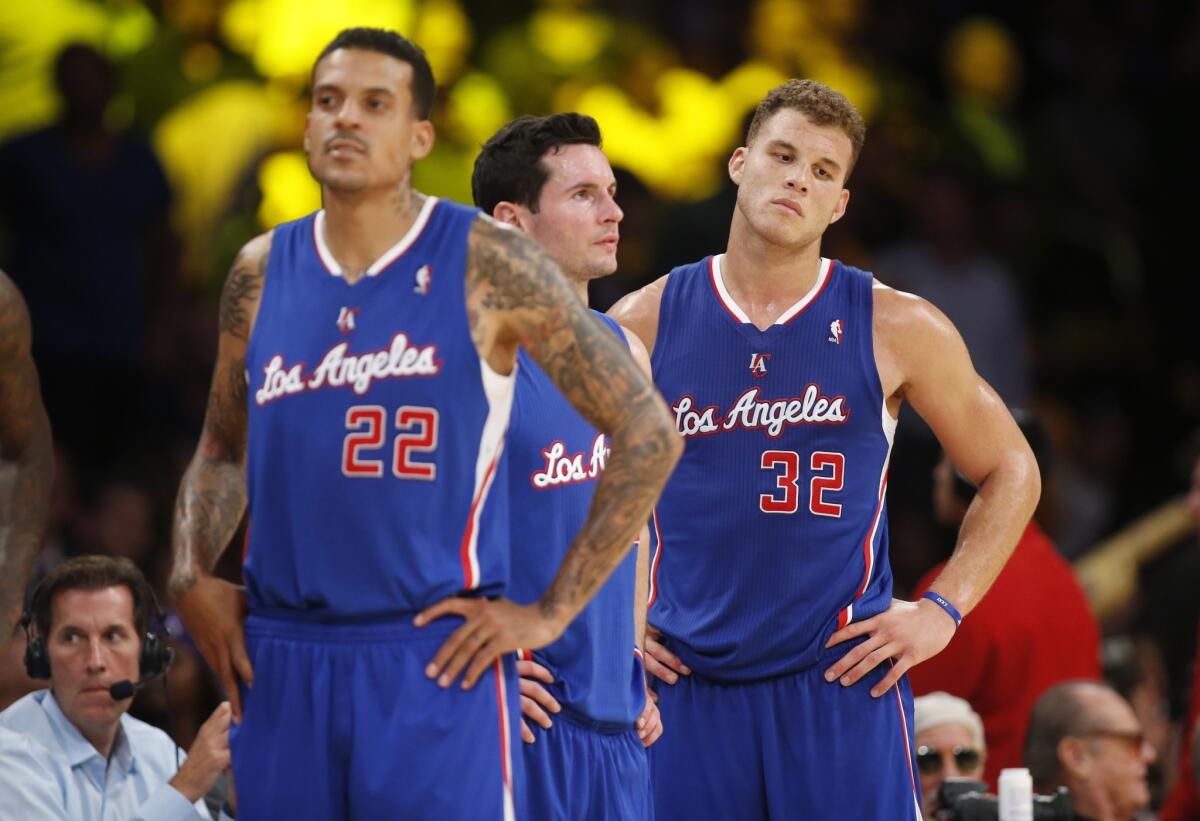 Matt Barnes, left, J.J. Redick and Blake Griffin wait for play to resume during the Clippers' loss to the Lakers on Tuesday night.