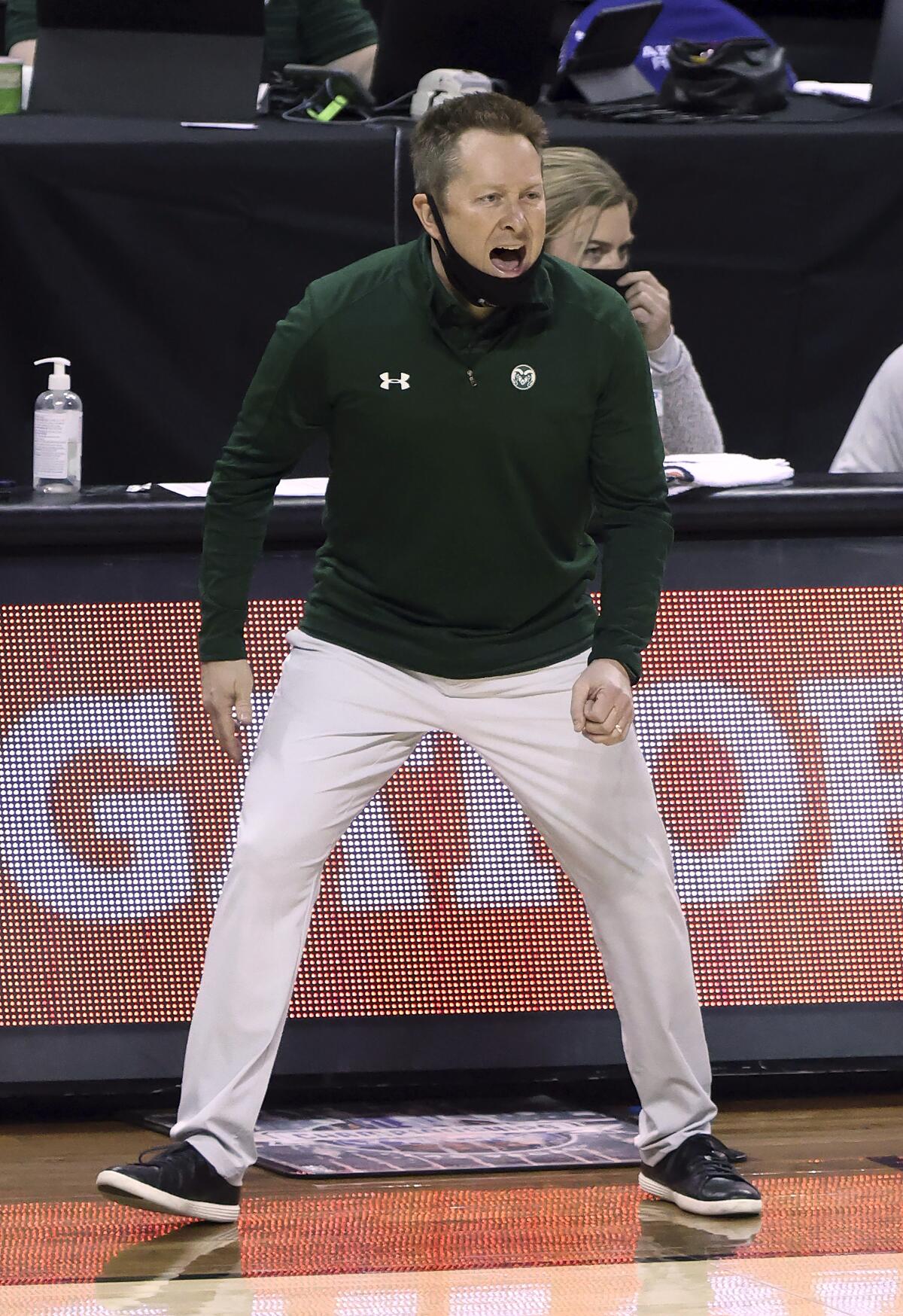 Colorado State head coach Niko Medved instructs his team during the first half of an NCAA college basketball game against Utah State in the semifinal round of the Mountain West Conference men's tournament Friday, March 12, 2021, in Las Vegas. (AP Photo/Isaac Brekken)