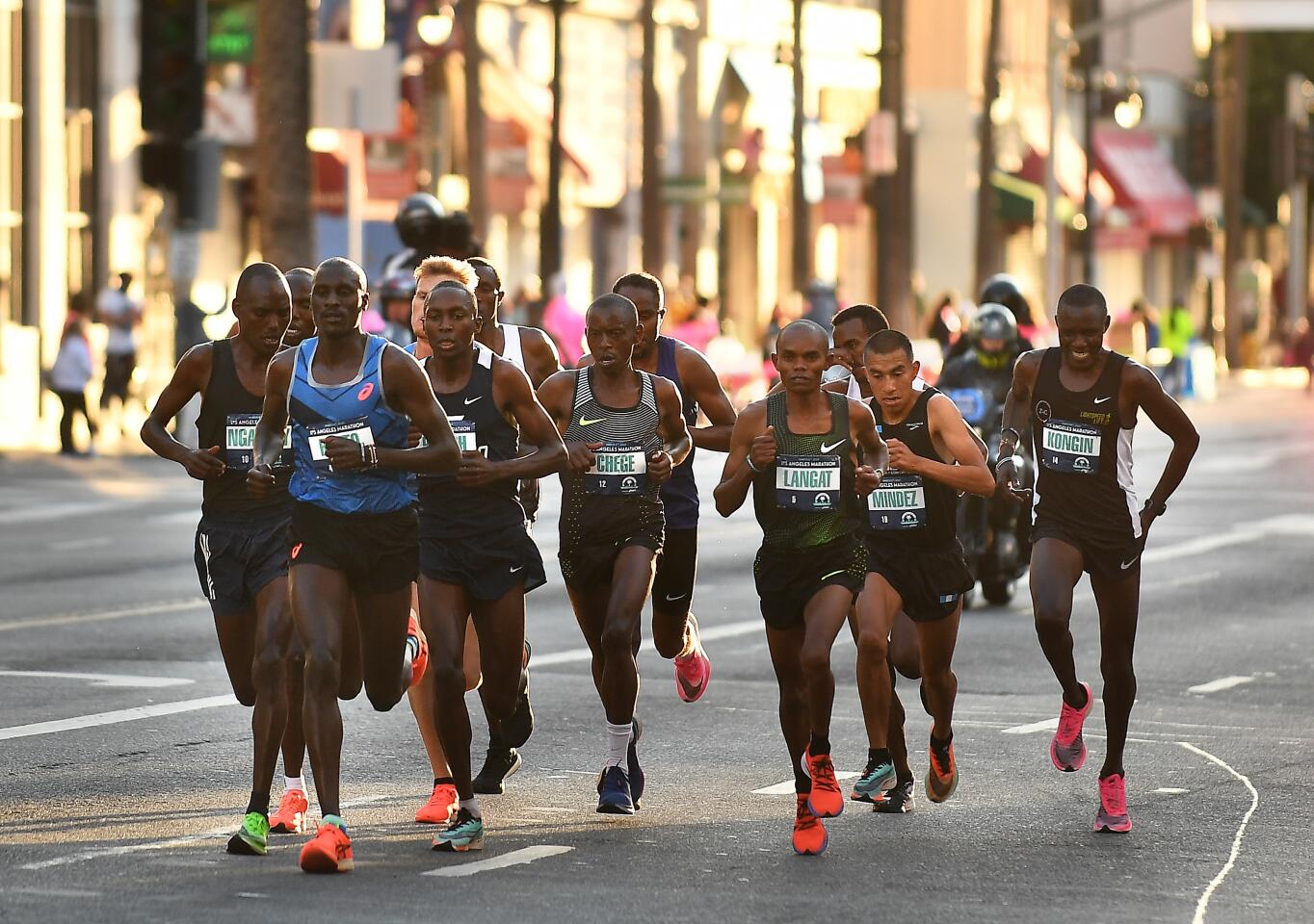 The lead pack of runners compete along Hollywood Blvd. in Hollywood Sunday during L.A. Marathon.