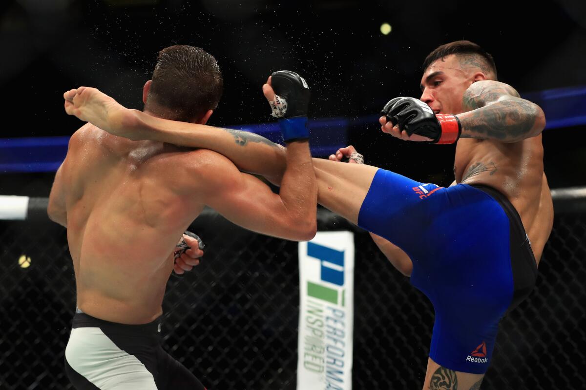 Andre Fili lands a kick against Calvin Kattar during their featherweight bout at UFC 214.