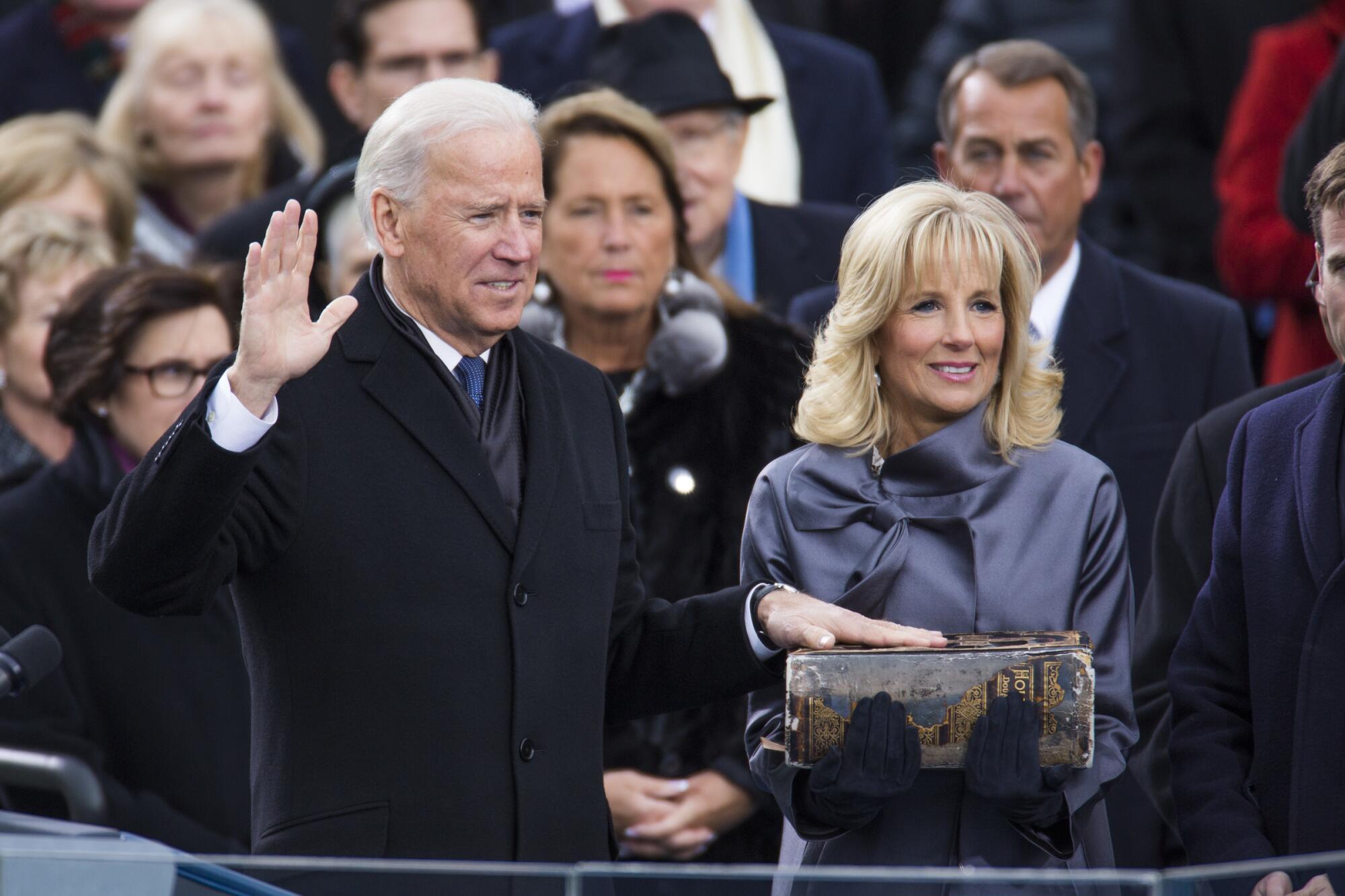 Jill Biden holds the Bible as Vice President Joe Biden takes the oath of office in 2013.